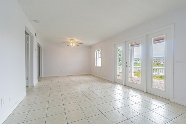 unfurnished room featuring light tile patterned floors and ceiling fan