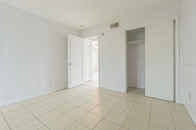 unfurnished bedroom featuring light tile patterned floors and a closet