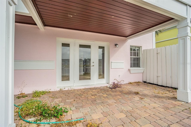 view of exterior entry featuring a patio area