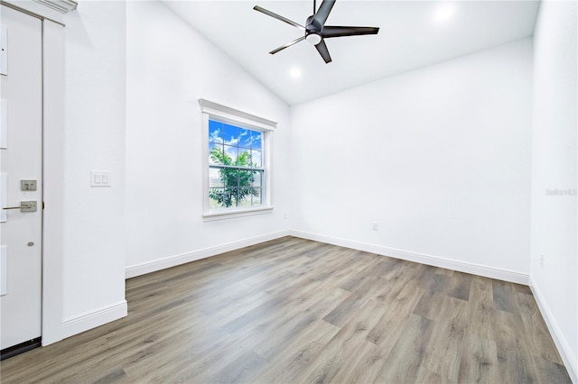 unfurnished room with ceiling fan, lofted ceiling, and light hardwood / wood-style flooring