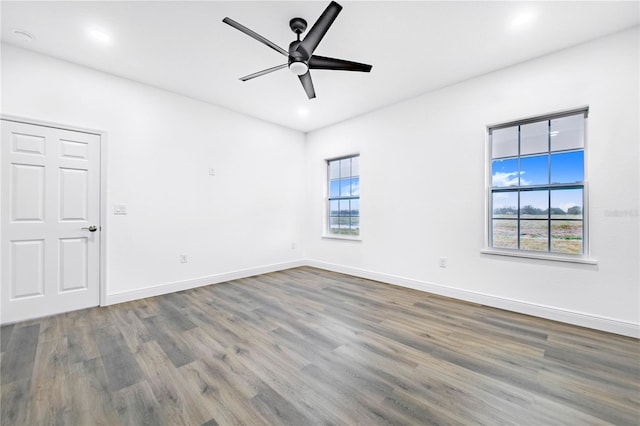 spare room with hardwood / wood-style flooring and ceiling fan