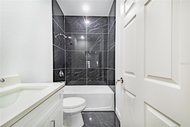 full bathroom with tiled shower / bath, vanity, and toilet