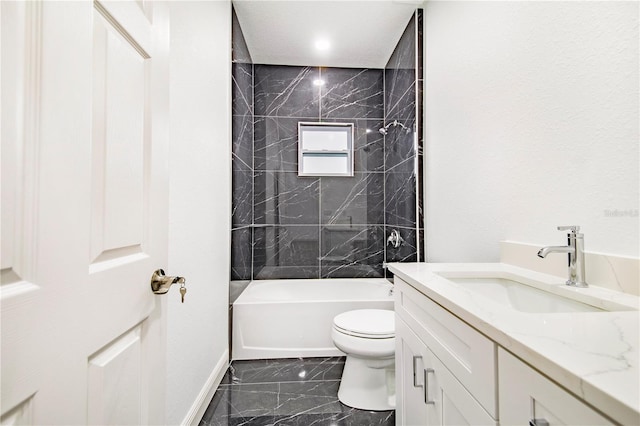 full bathroom featuring vanity, tiled shower / bath combo, and toilet