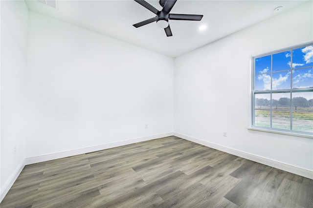 spare room with wood-type flooring and ceiling fan