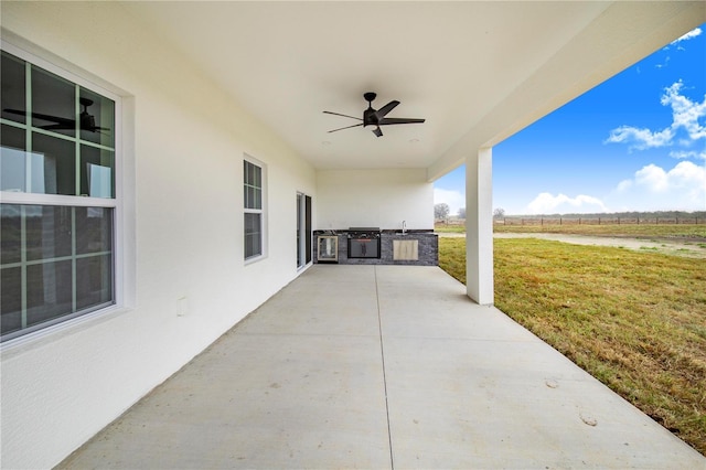 view of patio / terrace featuring area for grilling, sink, grilling area, and ceiling fan