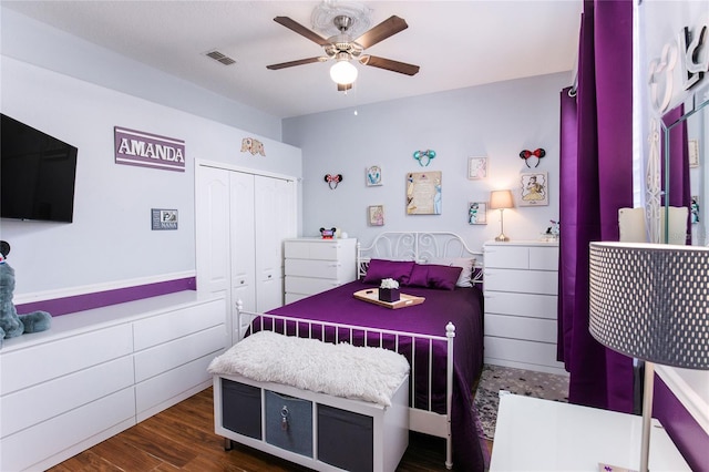 bedroom featuring dark hardwood / wood-style floors, a closet, and ceiling fan