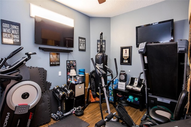 exercise room featuring a textured ceiling and ceiling fan