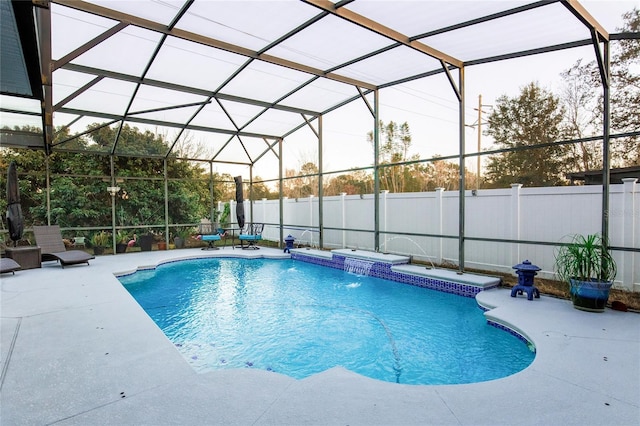 view of swimming pool with pool water feature, a lanai, and a patio