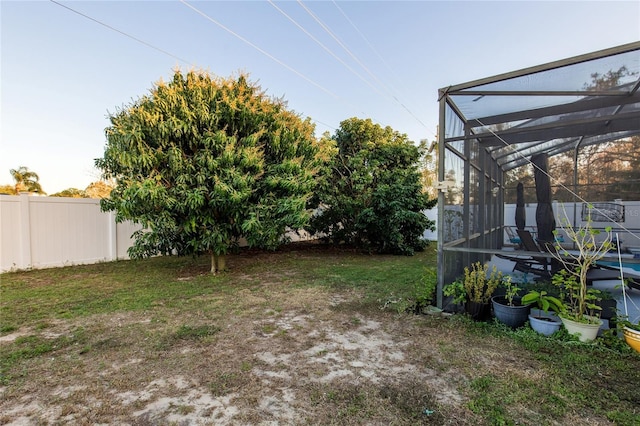 view of yard with glass enclosure