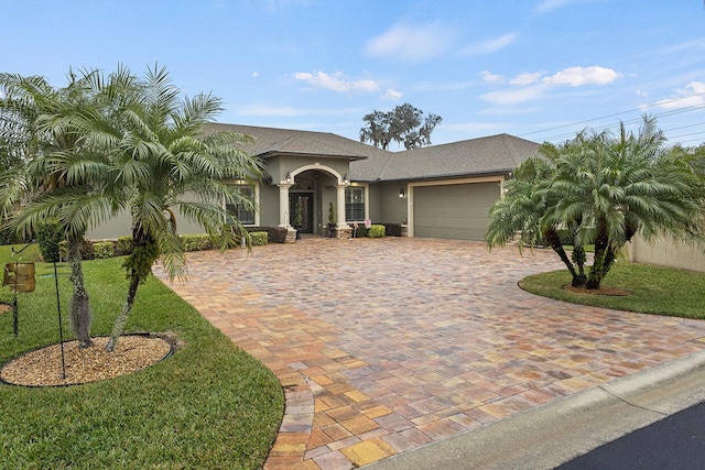 view of front facade with a garage and a front lawn