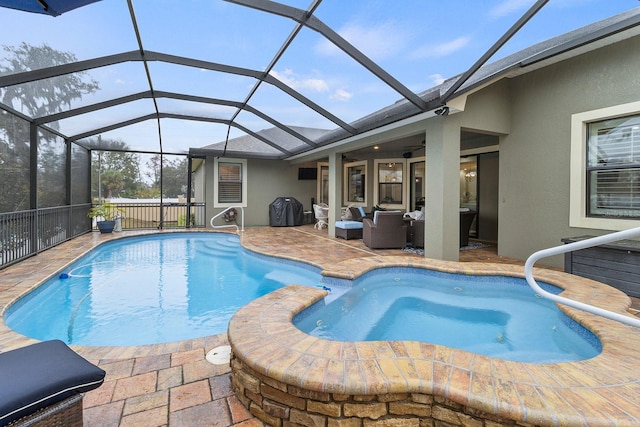 view of swimming pool featuring ceiling fan, a patio, an outdoor hangout area, and glass enclosure