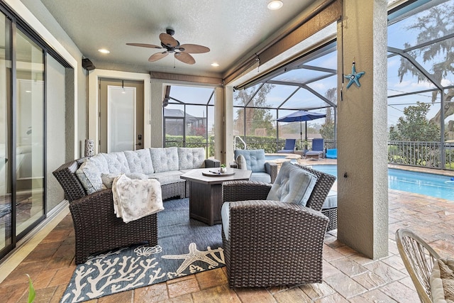 sunroom with ceiling fan