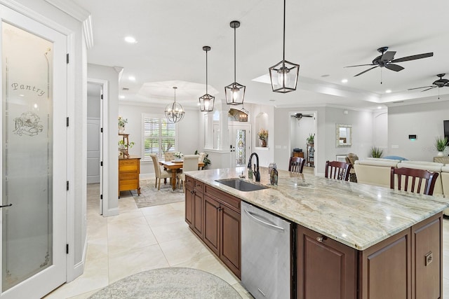 kitchen featuring pendant lighting, sink, crown molding, and stainless steel dishwasher