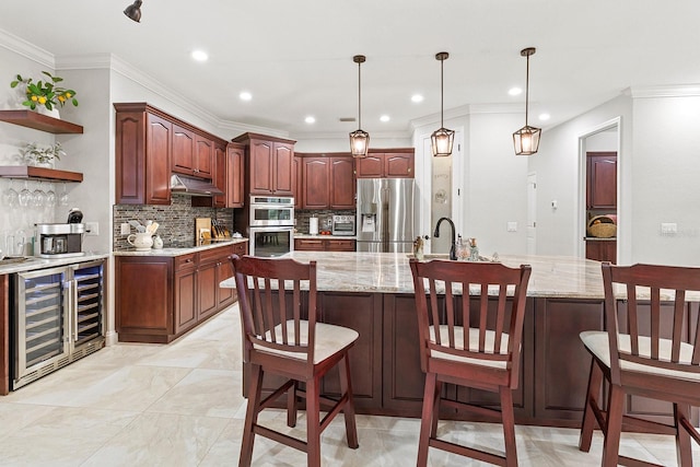 kitchen featuring wine cooler, a kitchen bar, hanging light fixtures, light stone counters, and stainless steel appliances