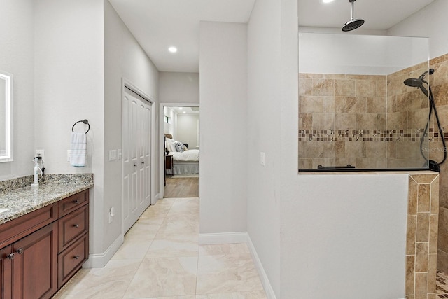 bathroom with vanity and tiled shower