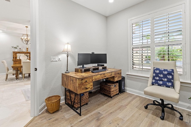 home office with light hardwood / wood-style floors and a chandelier