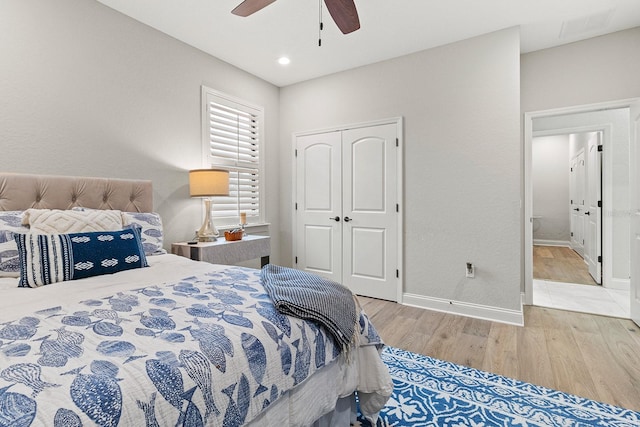 bedroom featuring wood-type flooring, a closet, and ceiling fan