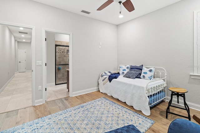 bedroom featuring connected bathroom, hardwood / wood-style floors, and ceiling fan