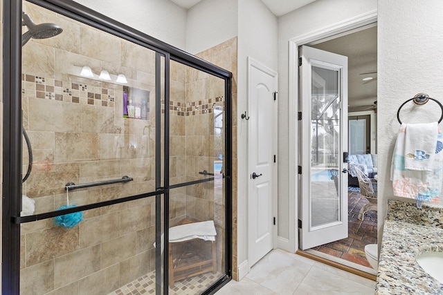 bathroom featuring vanity, toilet, and an enclosed shower