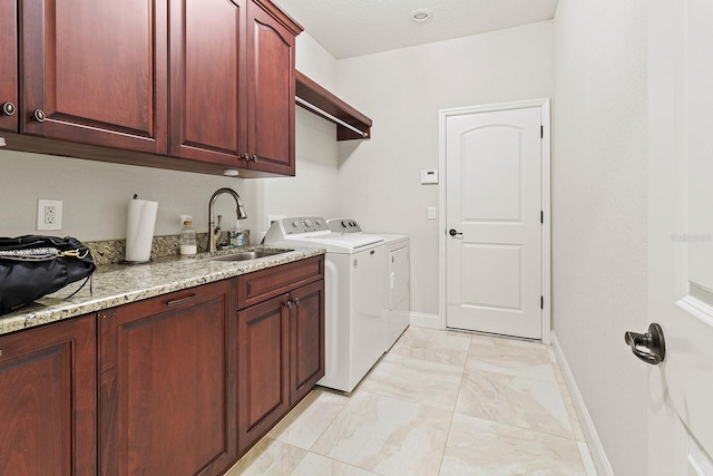 laundry room featuring cabinets, sink, and washing machine and dryer