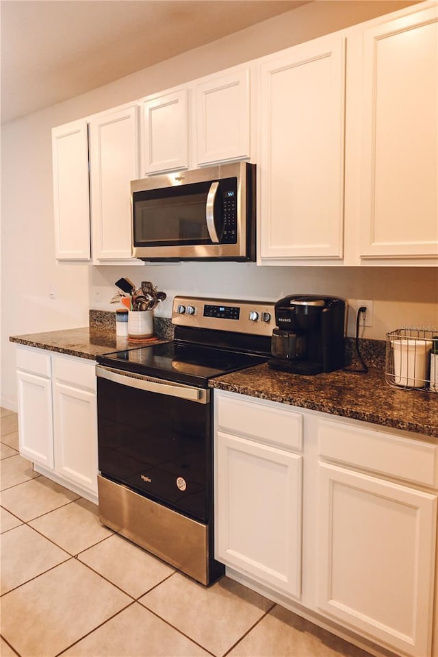 kitchen with light tile patterned floors, white cabinets, and appliances with stainless steel finishes