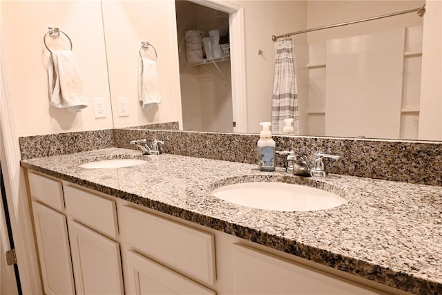 bathroom featuring vanity and curtained shower