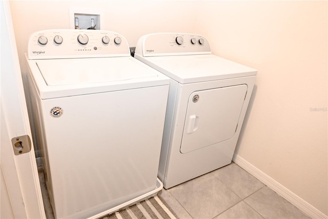 washroom featuring light tile patterned floors and washing machine and clothes dryer