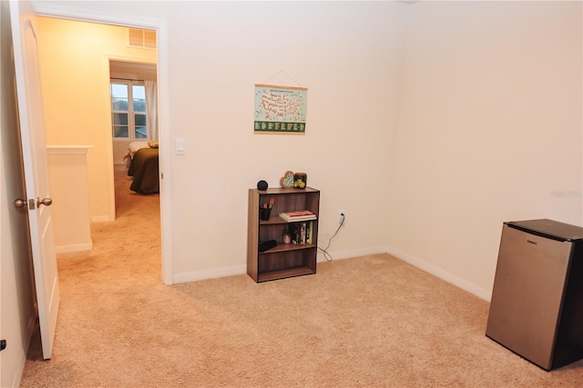 hall with light colored carpet