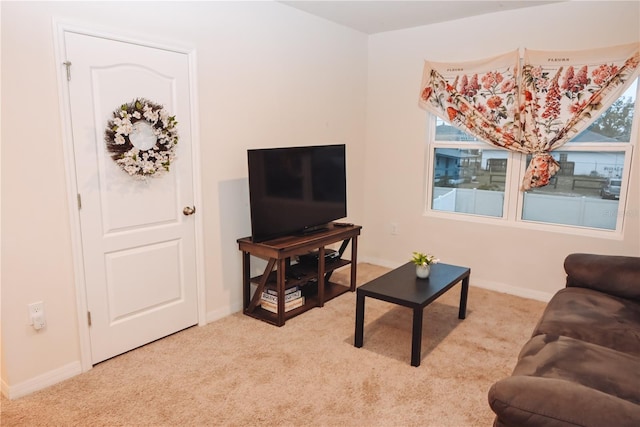 living room with plenty of natural light and light colored carpet