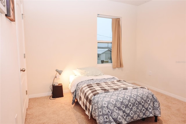 bedroom featuring light colored carpet