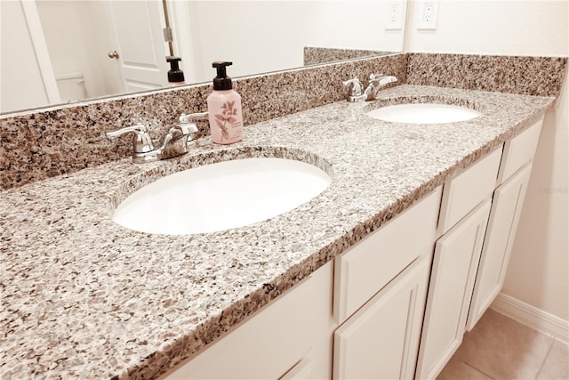 bathroom with vanity, tile patterned flooring, and toilet