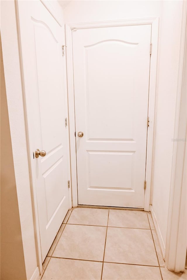 doorway to outside featuring light tile patterned floors