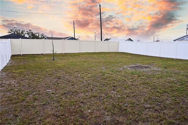 view of yard at dusk