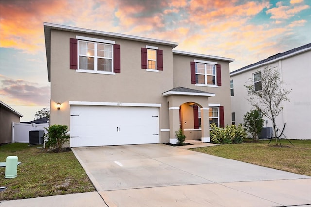 1726 Eagle Hammock Blvd, Eagle Lake, FL 33839 - traditional home featuring stucco siding, a garage, concrete driveway, and a yard