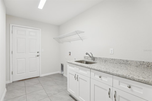 laundry room with sink, light tile patterned floors, hookup for a washing machine, cabinets, and hookup for an electric dryer