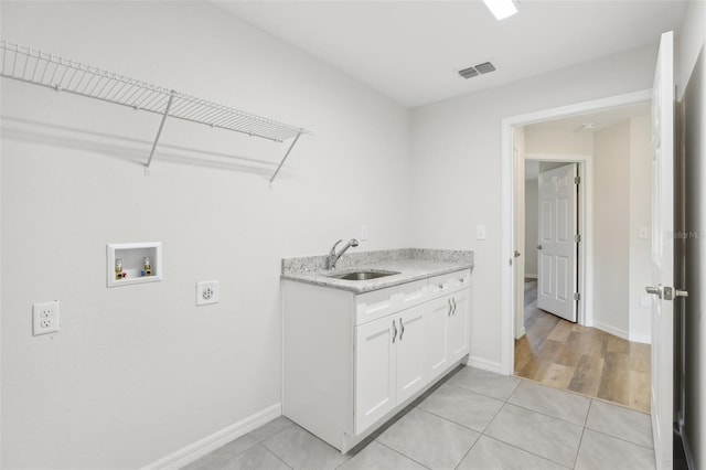 clothes washing area featuring washer hookup, sink, light tile patterned floors, and electric dryer hookup