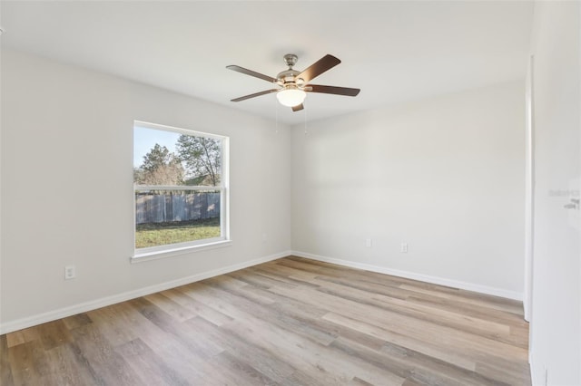 spare room with ceiling fan and light wood-type flooring