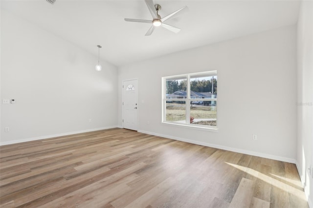 empty room featuring ceiling fan, lofted ceiling, and light hardwood / wood-style flooring