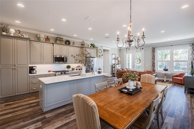 dining room featuring dark wood-type flooring, crown molding, and french doors