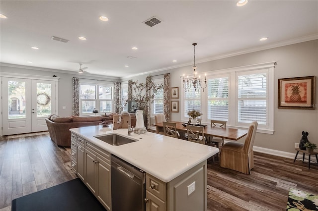 kitchen featuring sink, a kitchen island with sink, hanging light fixtures, ornamental molding, and stainless steel dishwasher