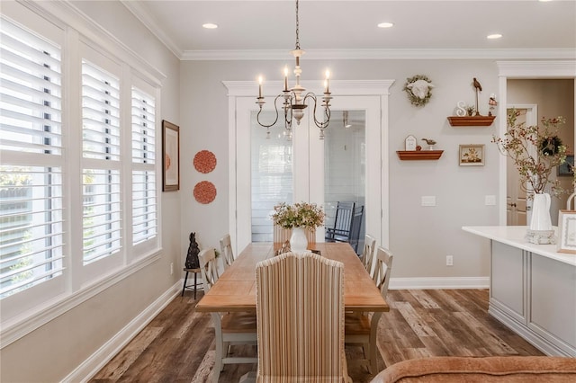 dining space with crown molding, dark hardwood / wood-style flooring, and a chandelier