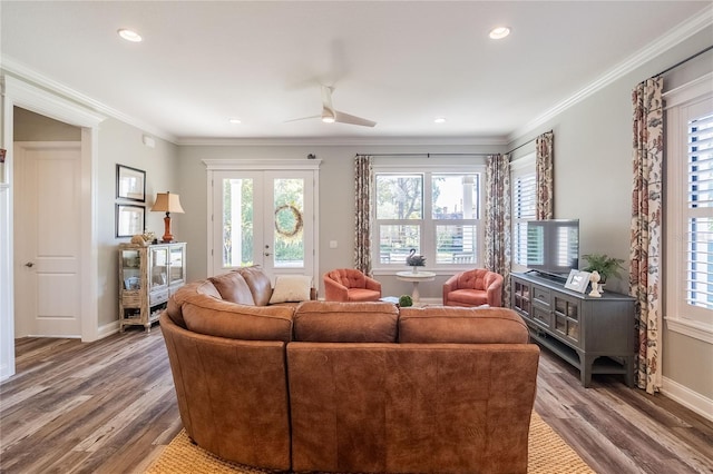 living room featuring hardwood / wood-style flooring, ornamental molding, ceiling fan, and french doors