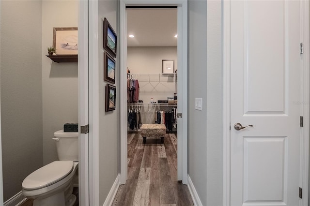 bathroom featuring wood-type flooring and toilet