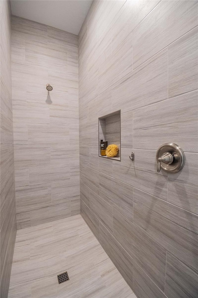 bathroom with a tile shower