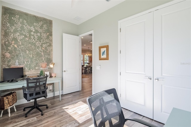 office with light hardwood / wood-style flooring