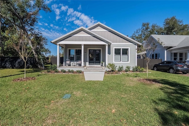 view of front facade with a front yard and covered porch