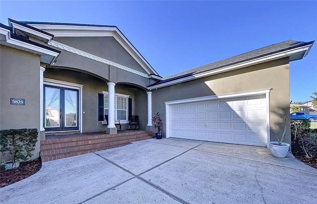 view of front of home with a garage and a porch