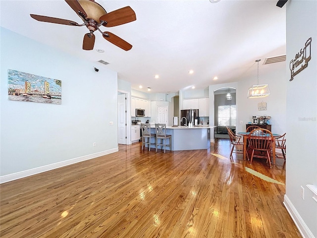 living room featuring hardwood / wood-style flooring and ceiling fan