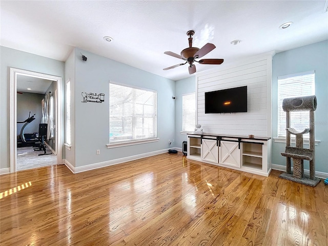 living room with hardwood / wood-style flooring and ceiling fan