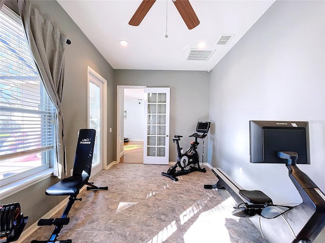 exercise room with ceiling fan and french doors